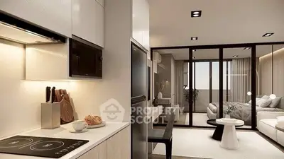 Modern open-layout kitchen and living room with sleek design and natural light.