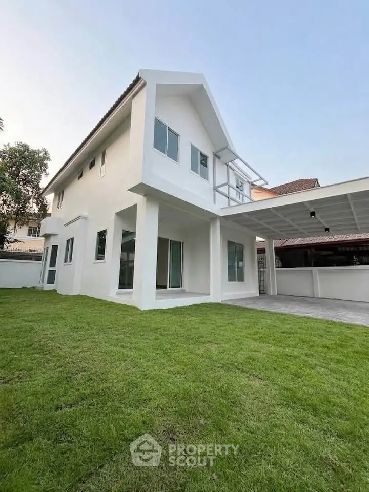 Modern two-story house with spacious lawn and sleek design