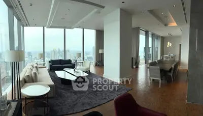 Luxurious high-rise living room with panoramic city views and elegant dining area.