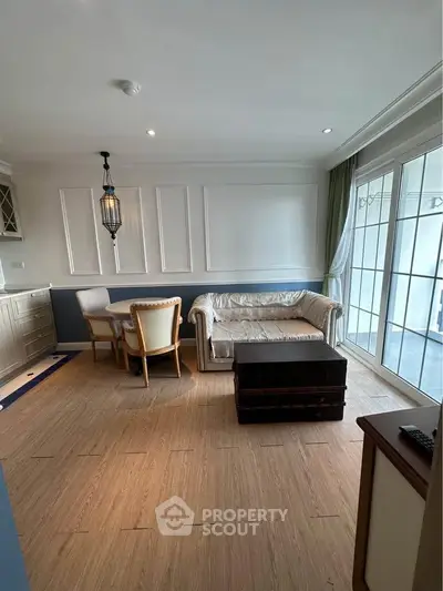 Charming living room with elegant decor and large windows for natural light.