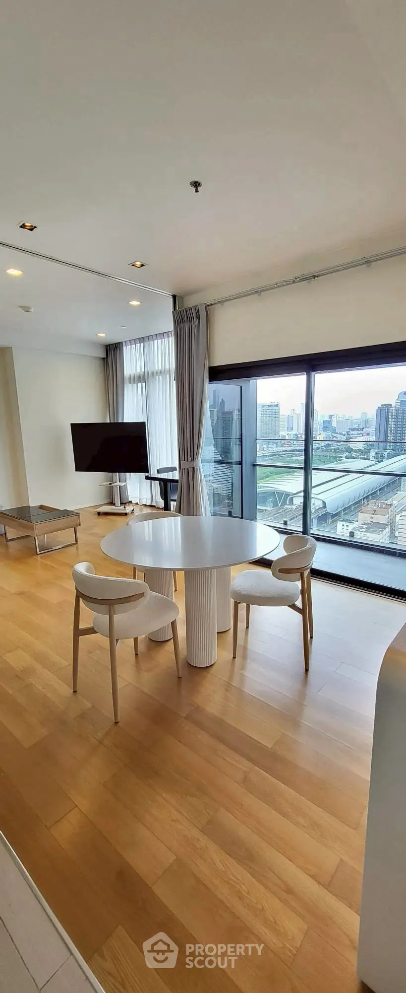 Modern living room with panoramic city view and stylish furniture