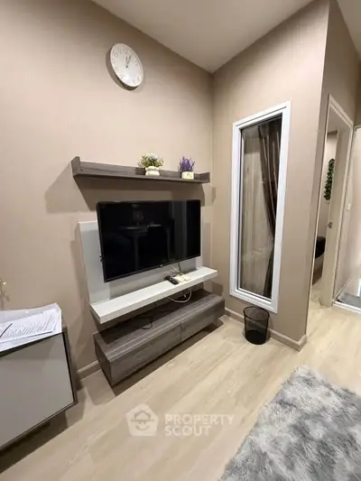 Modern living room with wall-mounted TV and stylish decor