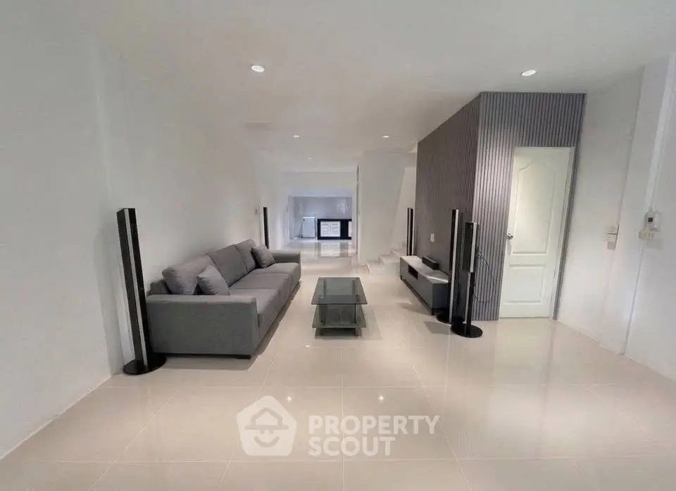 Spacious modern living room with sleek design and elegant furniture, perfect for relaxation and entertainment.