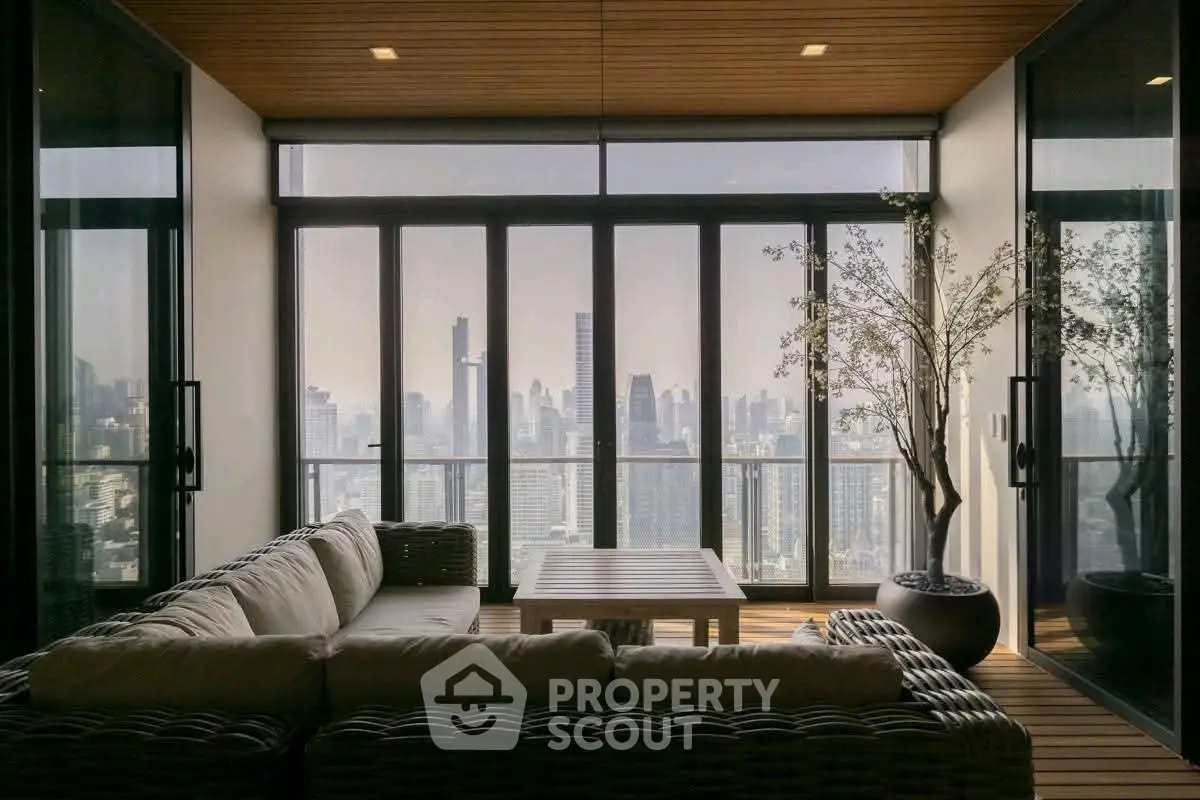 Luxurious living room with stunning city skyline view and modern decor.