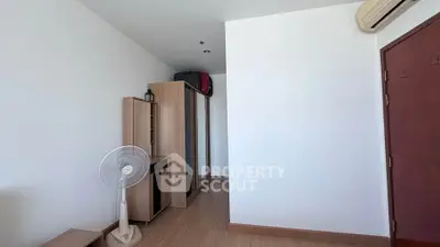 Minimalist bedroom with wooden wardrobe and air conditioning