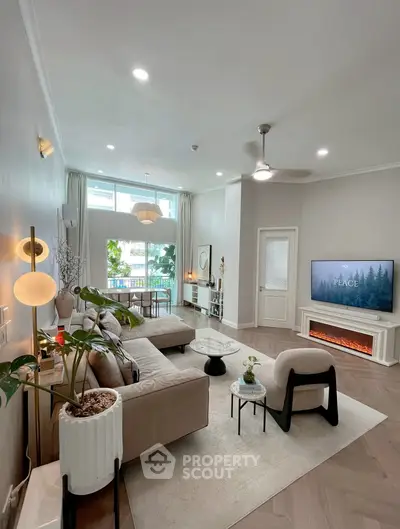 Spacious modern living room with elegant decor and large windows offering natural light.