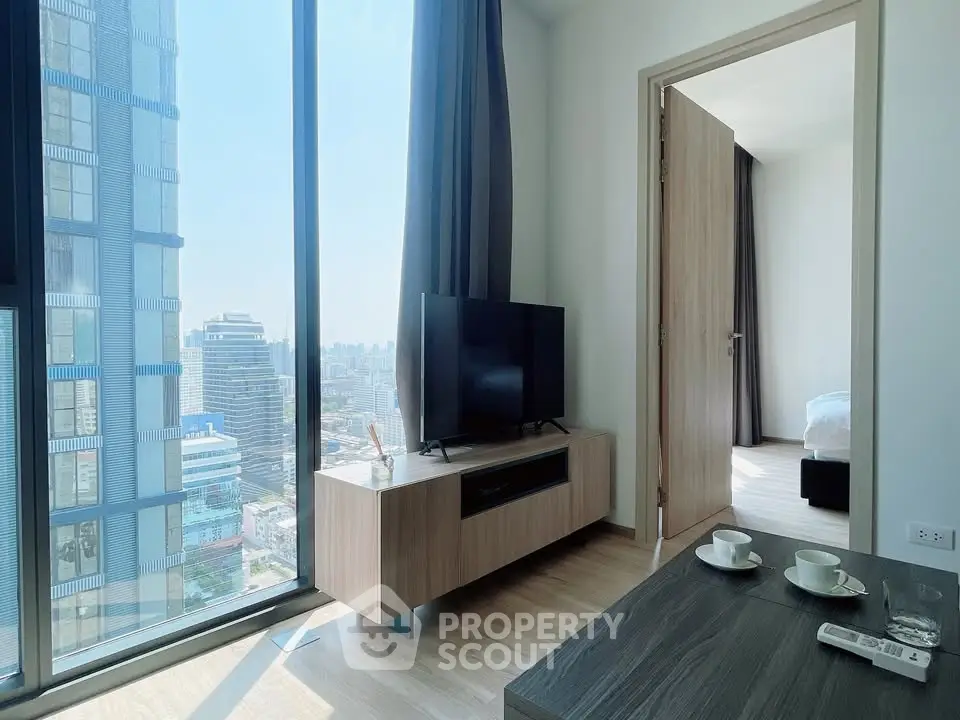 Modern living room with city view, sleek furniture, and natural light