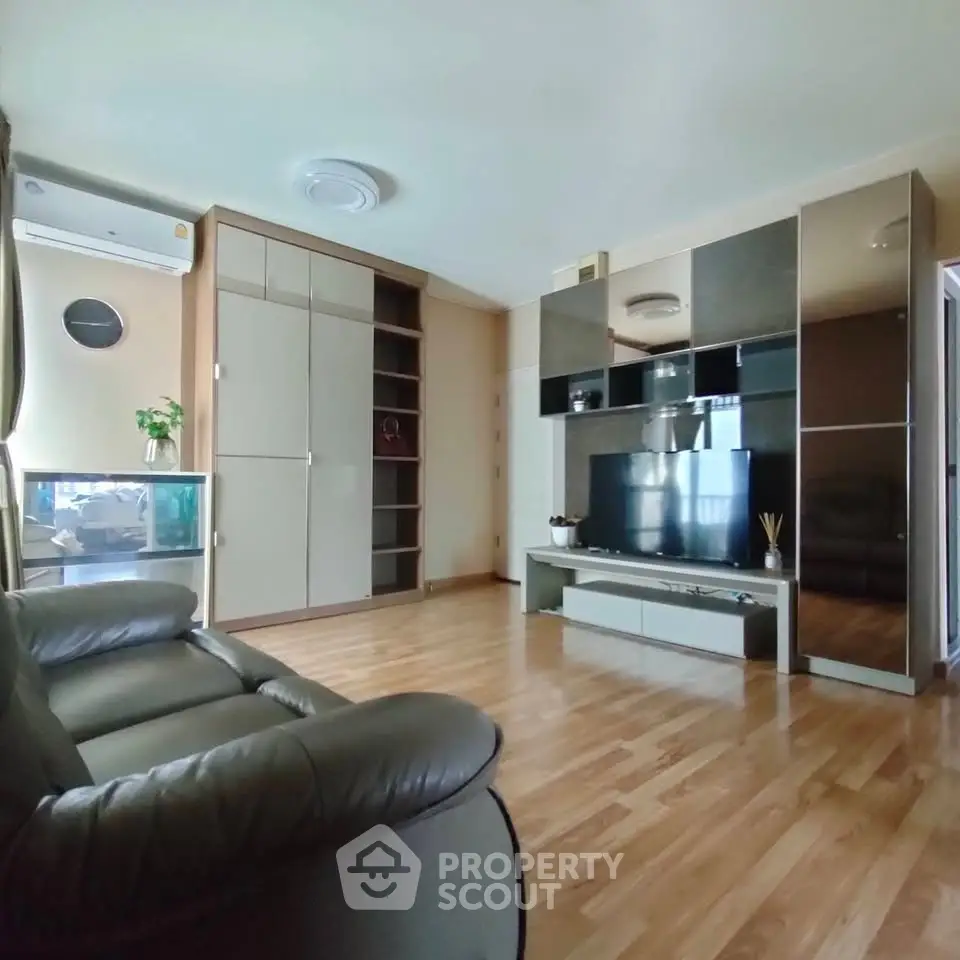 Spacious living room with modern entertainment center and cozy seating
