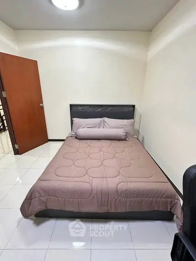 Cozy bedroom with modern decor and comfortable bed in a stylish apartment.