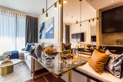 Luxurious modern living room with elegant decor and open kitchen layout.