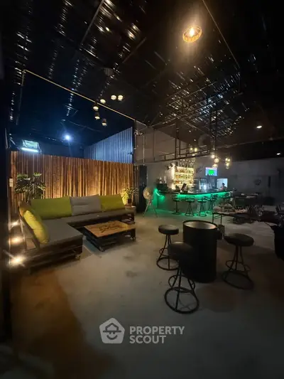 Stylish industrial-style living room with modern bar setup and cozy seating area.
