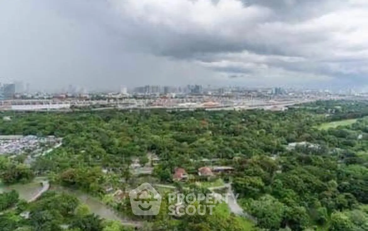 Stunning panoramic cityscape view with lush greenery and skyline.