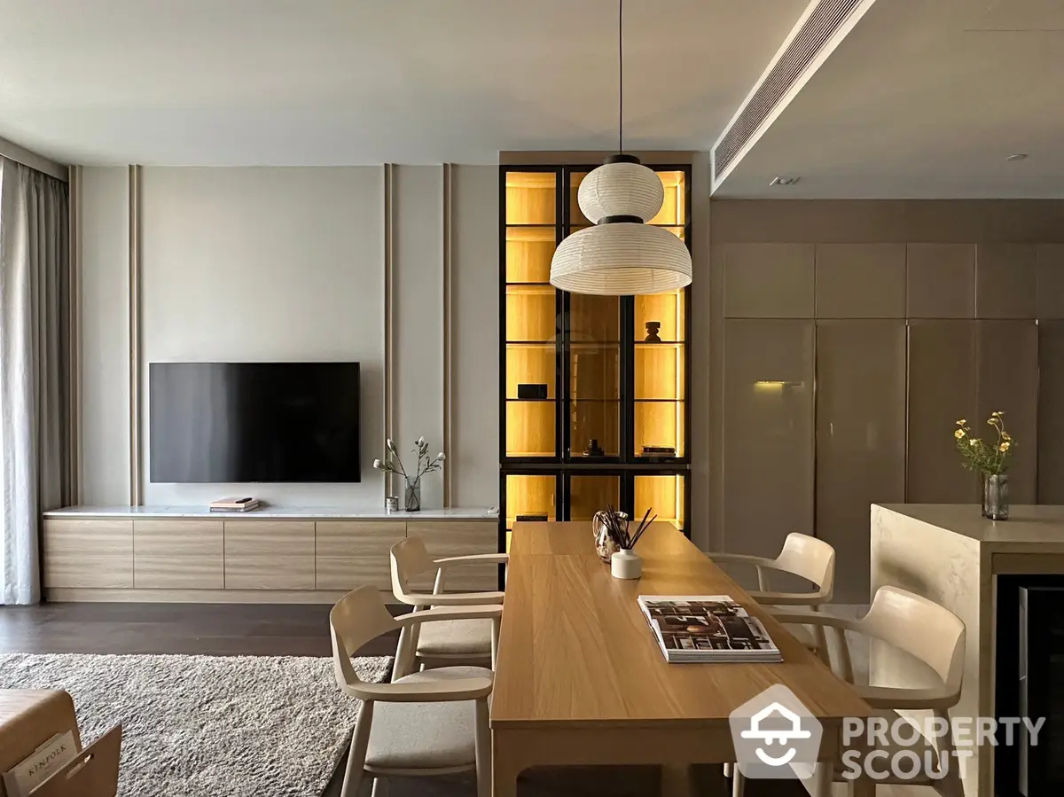 Elegant and spacious living room with modern dining area, featuring sleek furniture, ambient lighting, and a cozy atmosphere perfect for entertaining guests or relaxing.