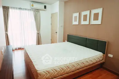 Cozy bedroom with modern decor and natural light in a stylish apartment.