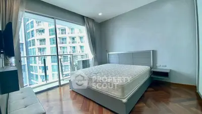 Spacious bedroom with large window and city view in modern apartment