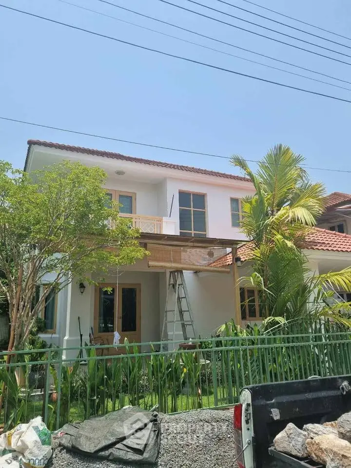 Charming two-story house with lush garden and modern design