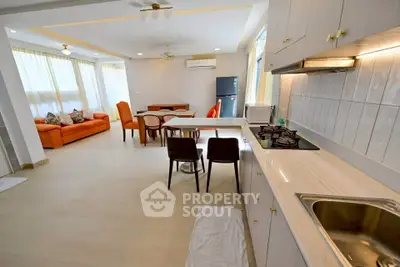 Spacious open layout kitchen and living area with modern appliances and natural light.