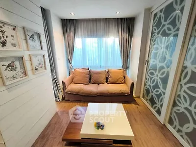 Cozy living room with stylish decor and natural light, featuring a comfortable sofa and elegant curtains.