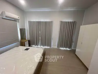 Spacious bedroom with modern furnishings and natural light