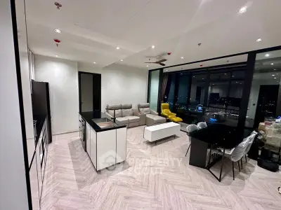 Spacious modern living room with herringbone floor pattern, sleek furniture, and panoramic city view through floor-to-ceiling windows.