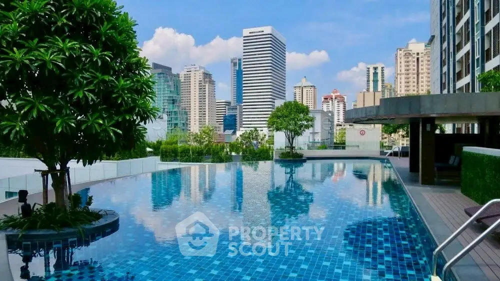 Luxurious rooftop pool with stunning city skyline views in modern high-rise building.