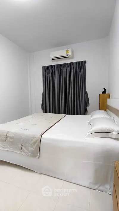 Cozy bedroom with modern air conditioning and elegant curtains