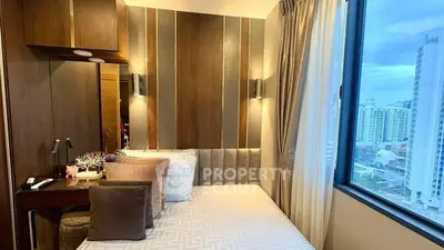 Luxurious bedroom with stunning city view and elegant decor in high-rise apartment.