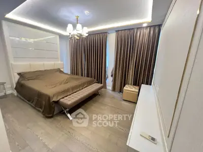 Luxurious bedroom with elegant lighting and floor-to-ceiling curtains