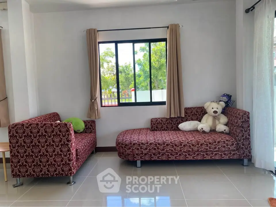Cozy living room with patterned sofas and large window view