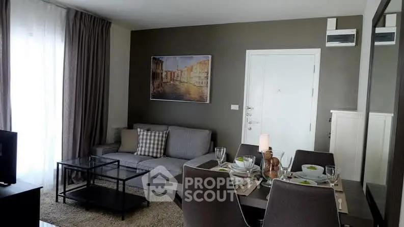 Stylish living room with modern decor and dining area, perfect for entertaining.