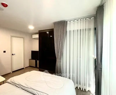 Modern bedroom with sleek design, featuring a large window with curtains and a stylish wardrobe.