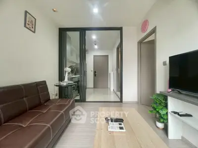 Modern living room with brown leather sofa and sleek decor in a cozy apartment.