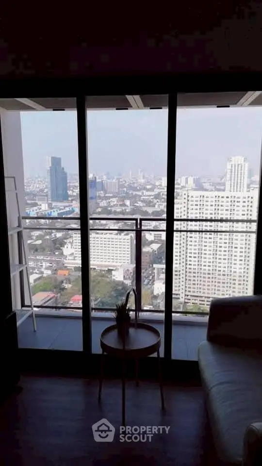 Stunning high-rise city view from modern apartment balcony.