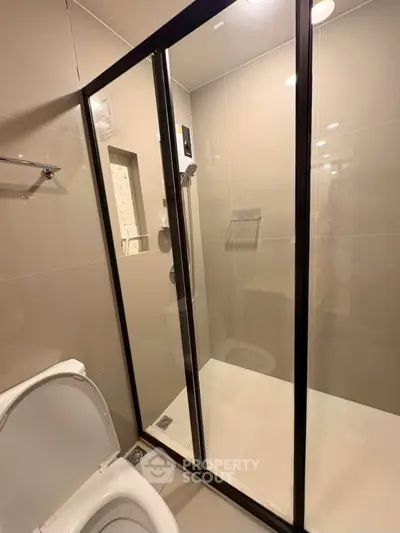Modern bathroom with glass shower enclosure and sleek fixtures