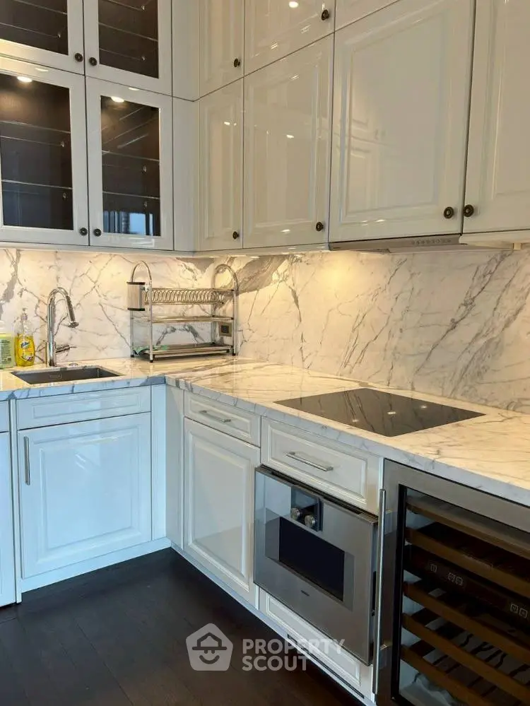 Luxurious modern kitchen with marble countertops and sleek cabinetry.