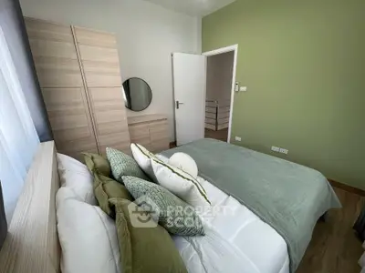 Cozy bedroom with green accents and modern furnishings