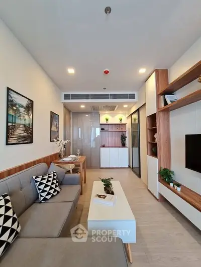 Modern living room with stylish decor and cozy seating in a contemporary apartment.