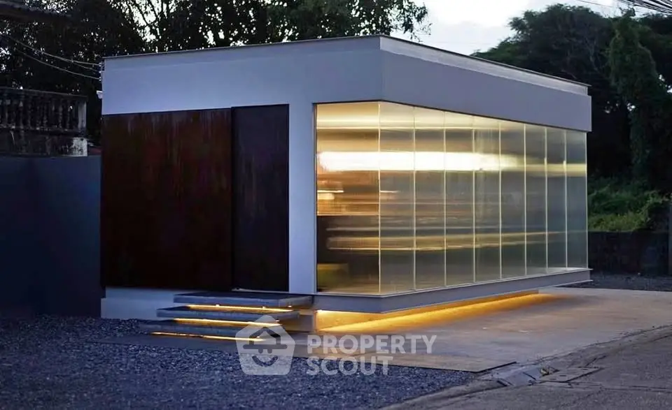 Modern minimalist building with sleek glass facade and ambient lighting
