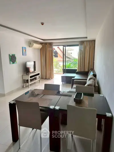 Spacious living room with modern furniture and large window view