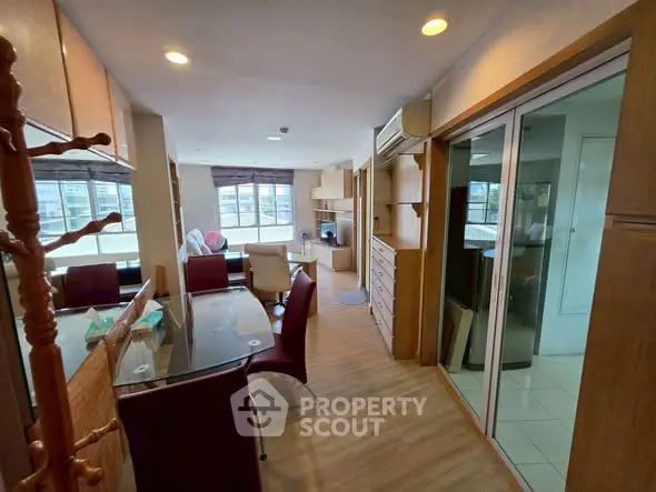 Spacious living room with modern furniture and large windows offering natural light.