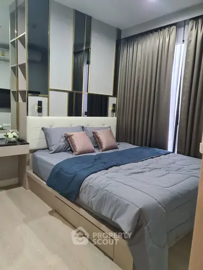 Modern bedroom with stylish decor and elegant bedding in a cozy apartment setting.