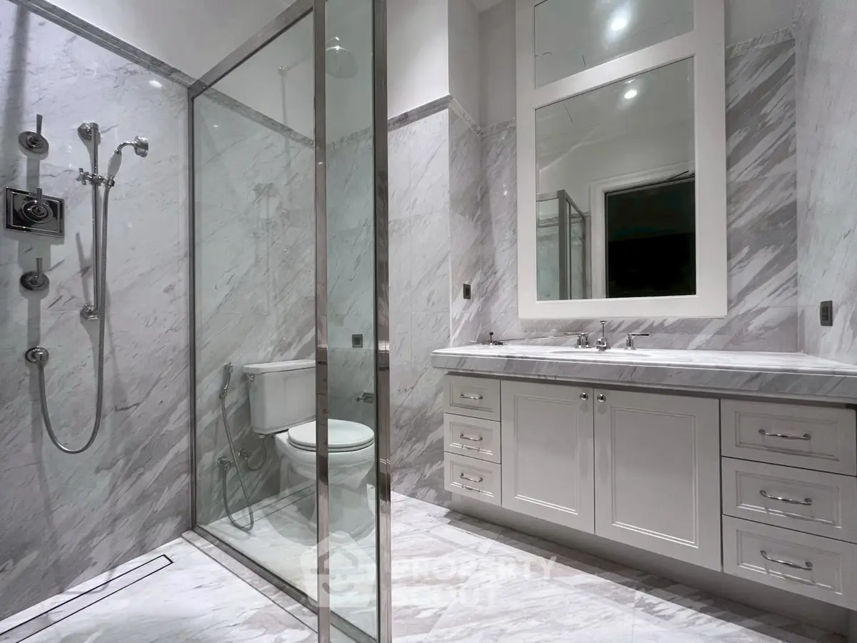 Luxurious marble bathroom with glass shower and elegant vanity
