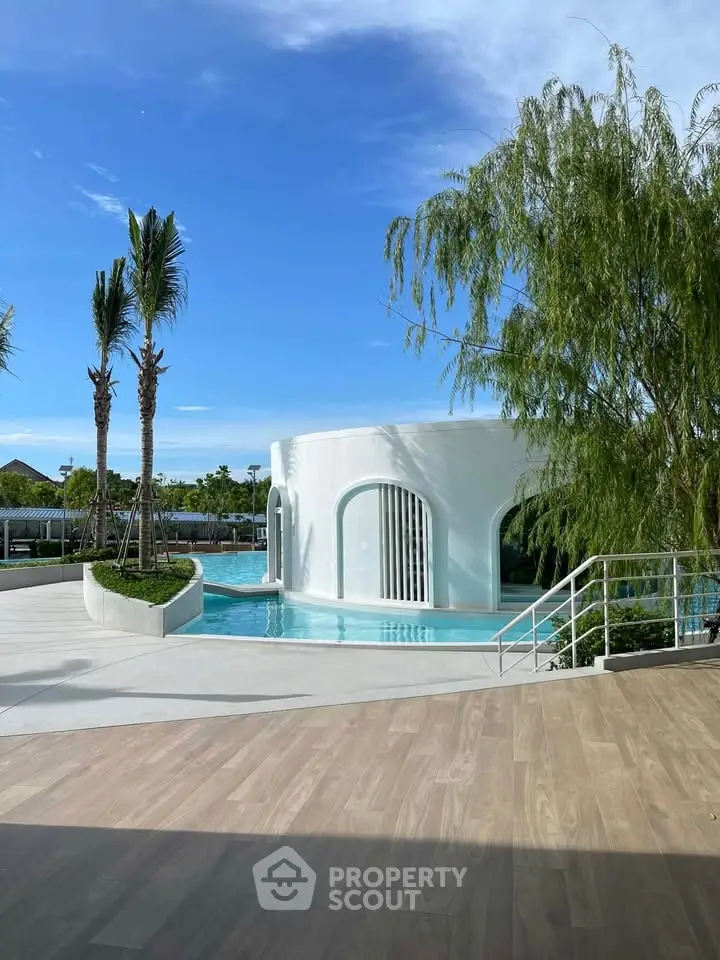 Stunning modern pool area with unique architectural design and lush greenery.