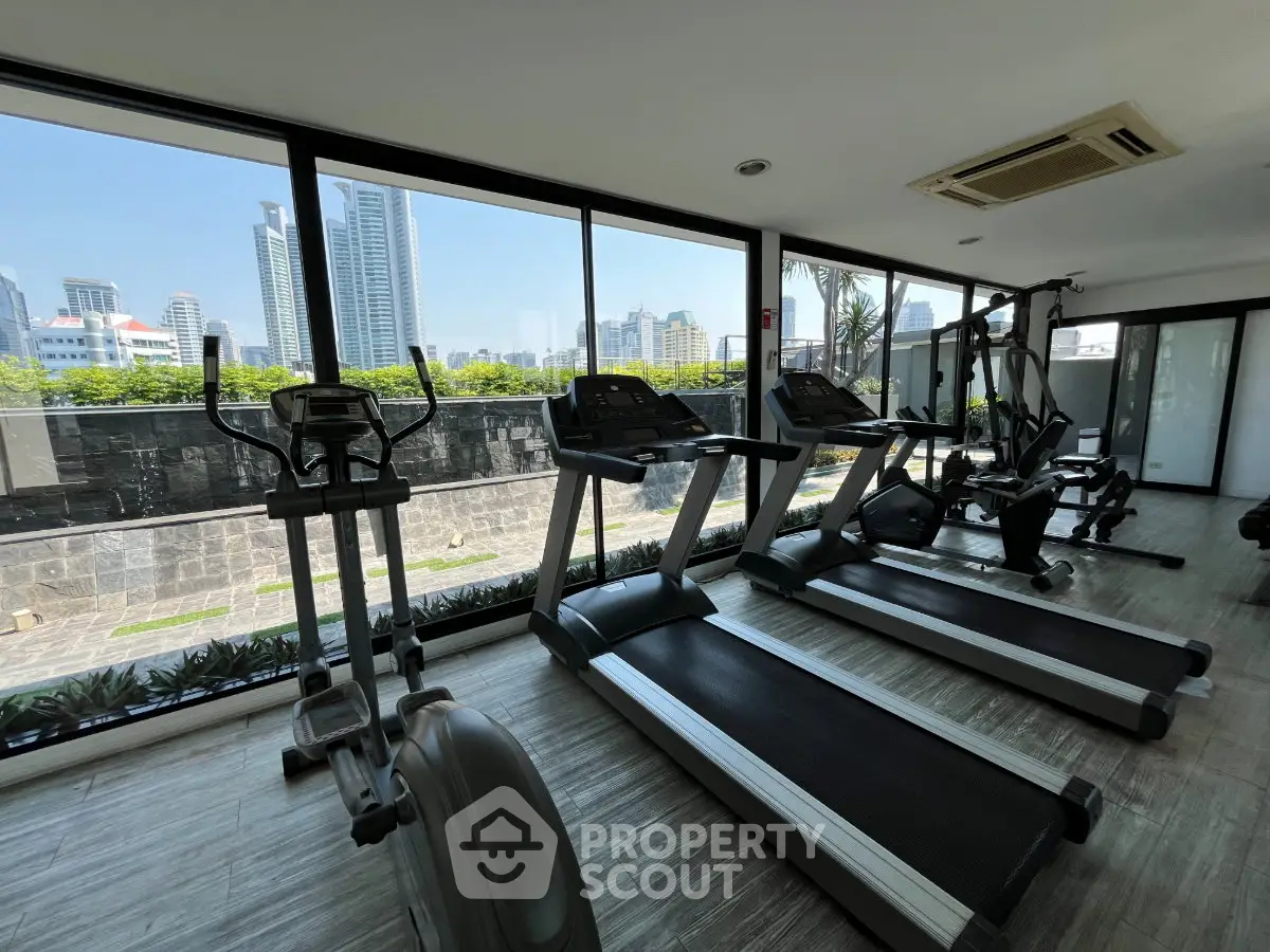 Modern gym with city view in luxury apartment building