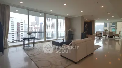 Spacious modern living room with panoramic city views and elegant decor.