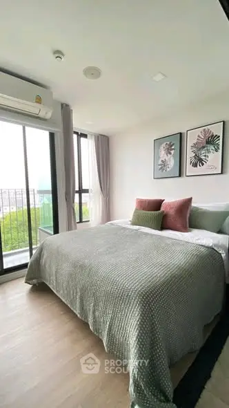 Stylish bedroom with large windows and modern decor, offering a serene and inviting atmosphere.