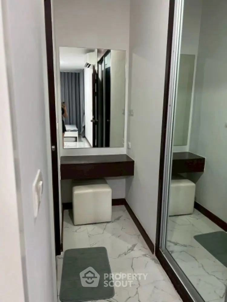 Modern bedroom with sleek vanity and mirrored closet doors