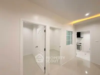 Modern apartment interior with sleek kitchen and bright hallway