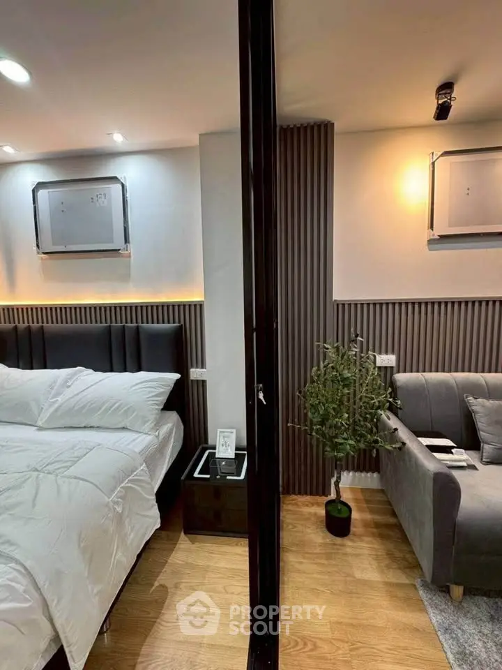 Modern bedroom and living area with stylish decor and cozy ambiance.