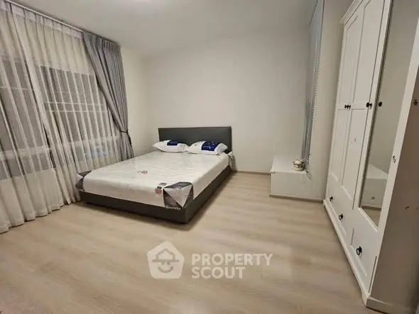 Spacious bedroom with modern decor and ample natural light